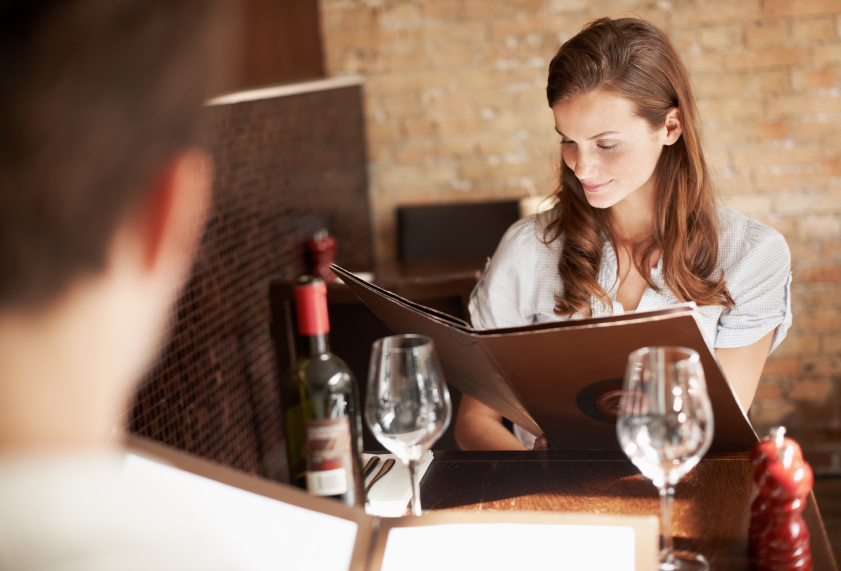 young woman browsing through a menu